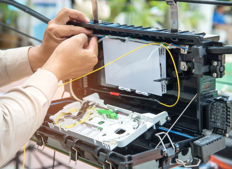 Technicians are installing fiber optic cabinets for high speed internet.